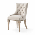Chaise en tissu beige avec pieds en bois sculpté